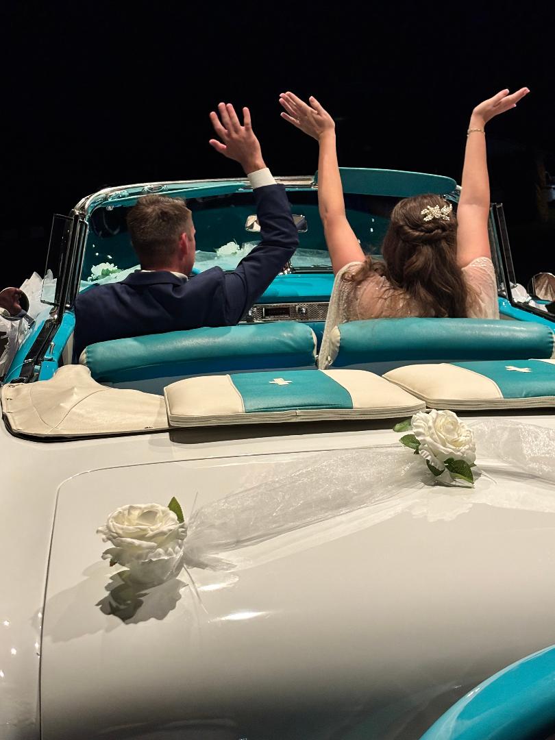 Newlyweds celebrating together from the back of Ole' Belle