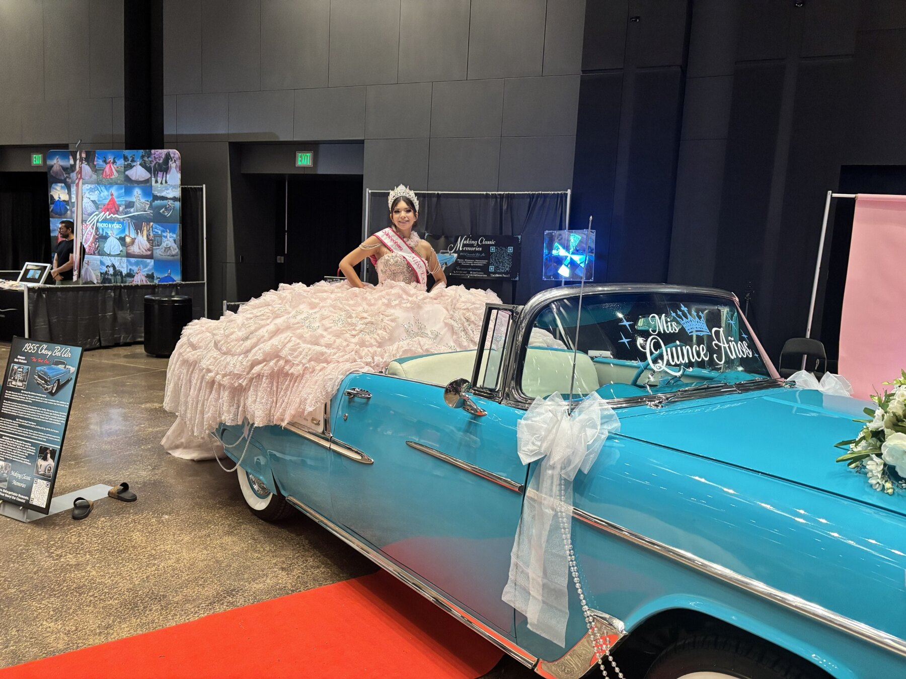 Young woman in a blush quinceañera gown posing behind Ole' Belle
