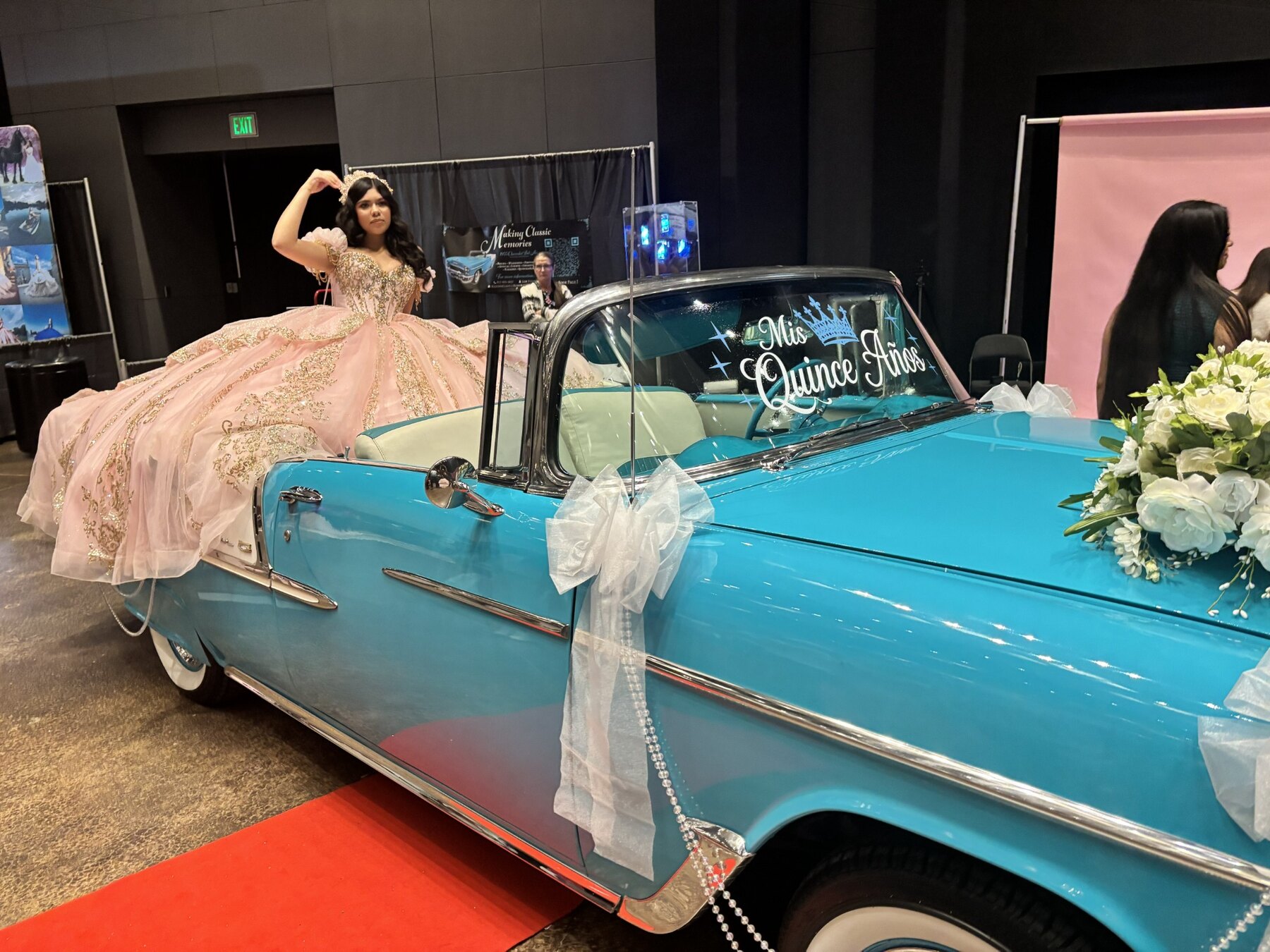 Young woman in a peach quinceañera gown posing beside Ole' Belle