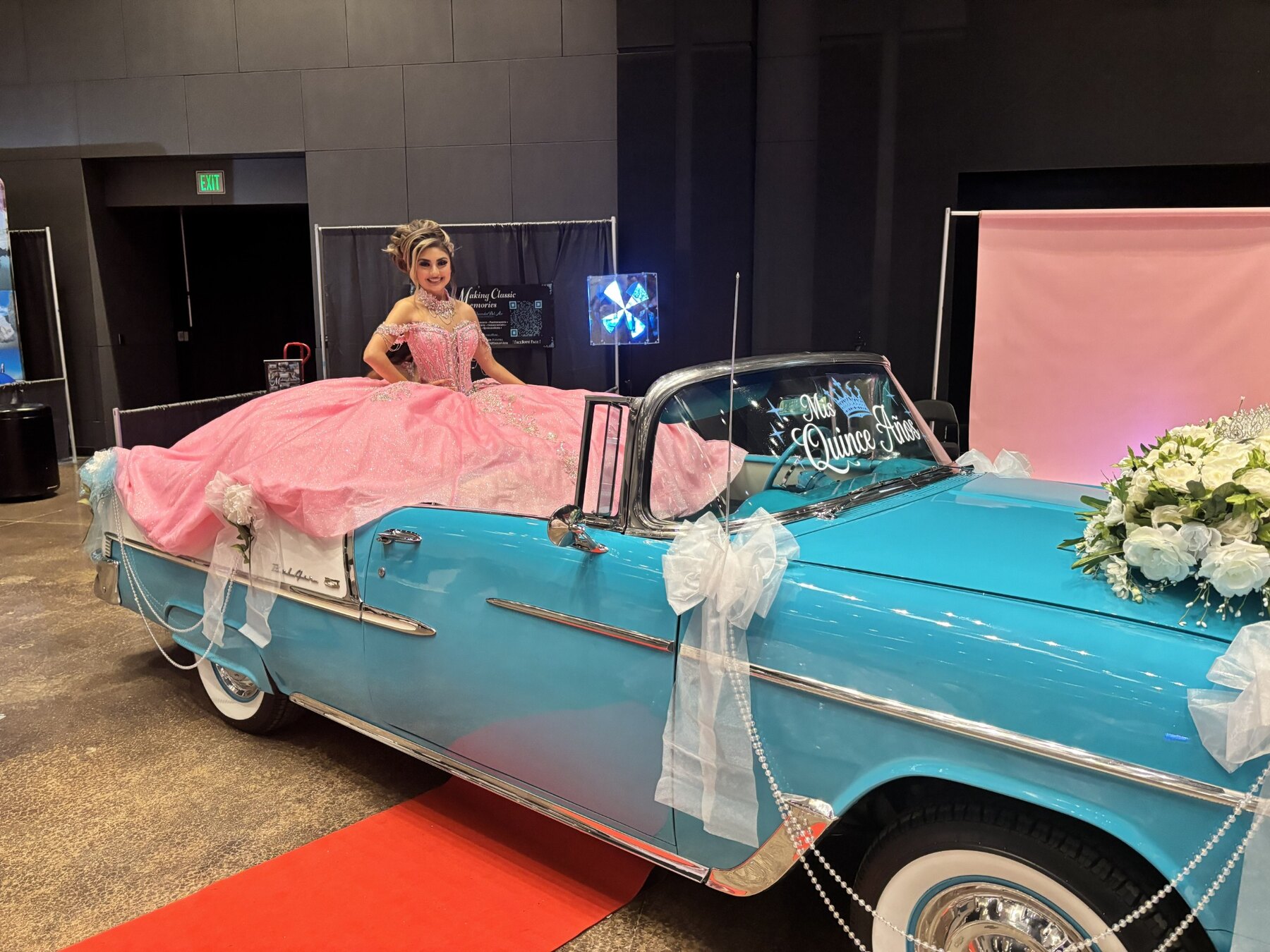 Young woman in a pink quinceañera gown seated in Ole' Belle